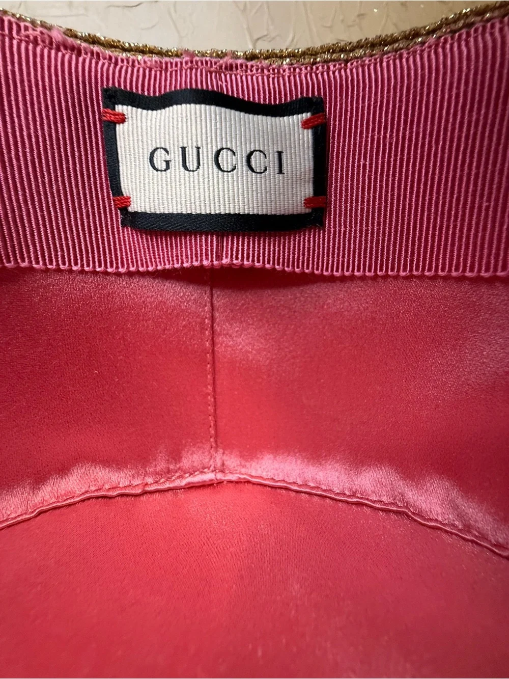 Gucci bee detail hat featuring a gold toned metallic woven design and blk ribbon